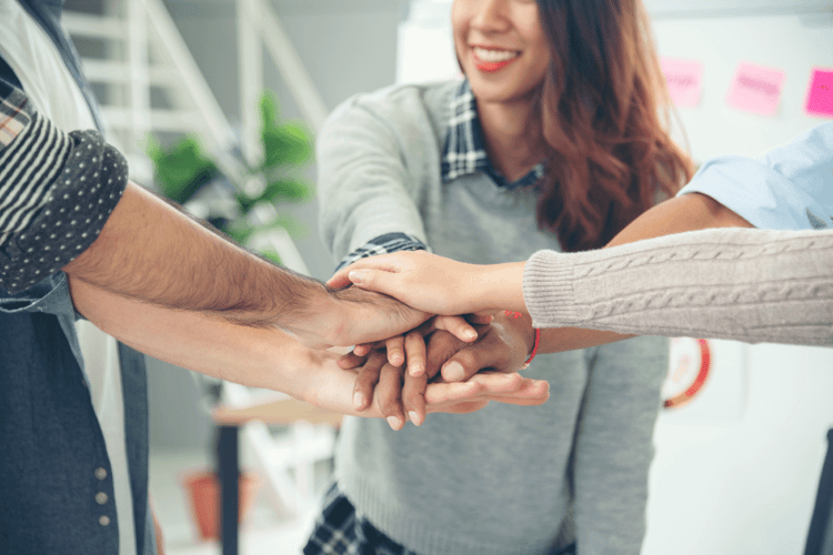 People with hands together